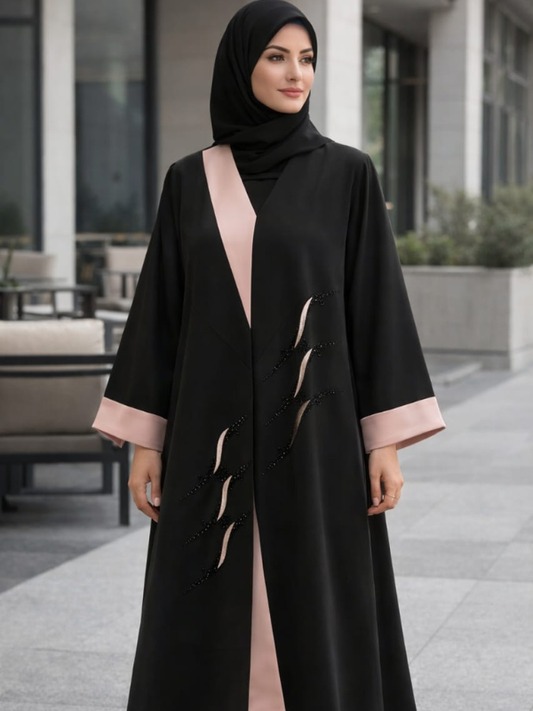 The black and blush beaded abaya worn with a black shella, from The Lamorah Dubai