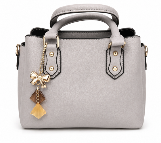 Dove grey pebbled winged tote with gold studs and a gold bow charm with amber and honey drops, from The Lamorah Dubai