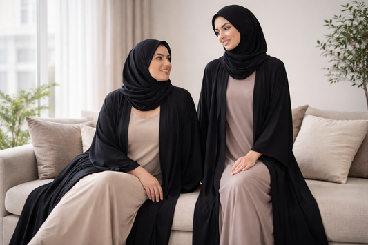 Women wearing open abayas with comfortable underdresses underneath showing layering for everyday wear