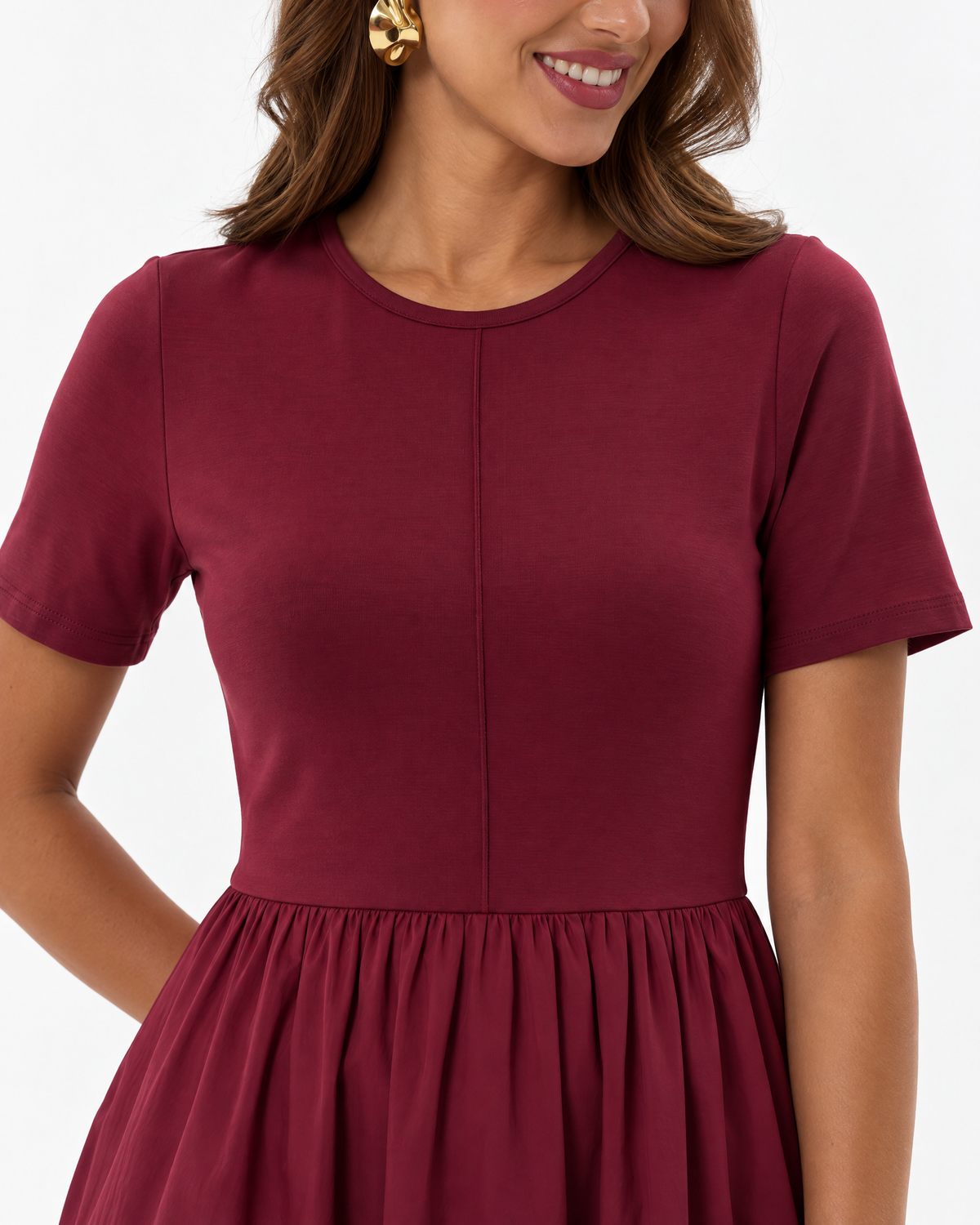 Close-up of THE LAMORAH burgundy dress showing the round neckline, short sleeves, centre-front bodice seam and gathered woven skirt.