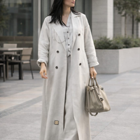 The off-white trench abaya worn open over a matching dress, from The Lamorah Dubai