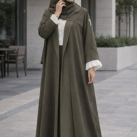 The olive pleated-panel abaya worn with a matching olive shella, from The Lamorah Dubai