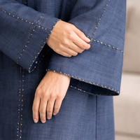 Close-up of a blue garment with a blurred background| THE LAMORAH