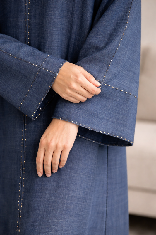 Close-up of a blue garment with a blurred background| THE LAMORAH