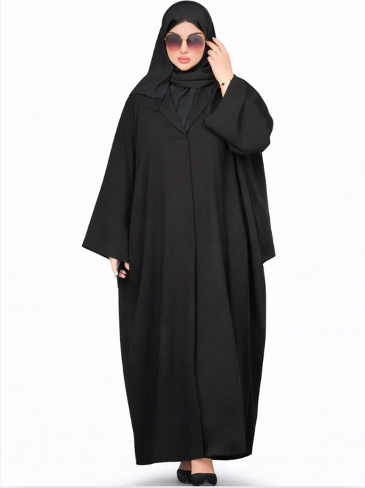 Person wearing a black abaya on a white background |THE LAMORAH
