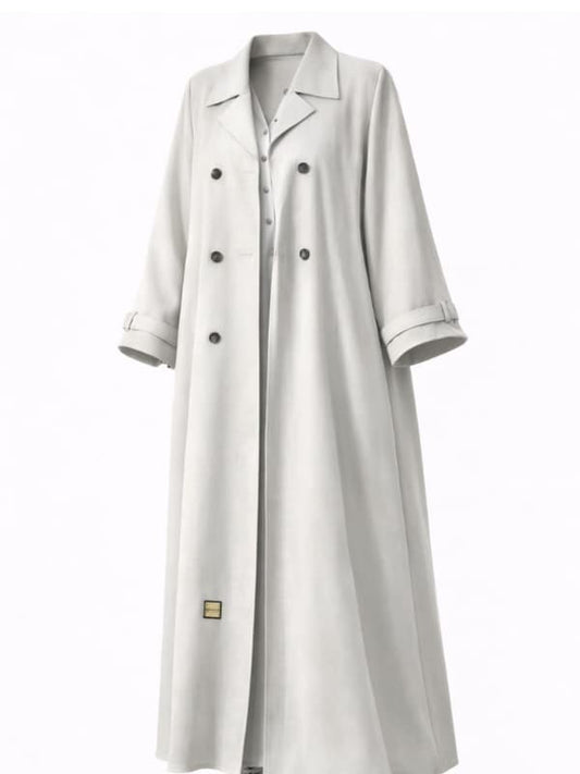 Off-white trench-style abaya with dark double-breasted buttons and a notched lapel, cut to measure by The Lamorah Dubai