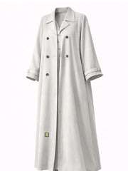 Off-white trench-style abaya with dark double-breasted buttons and a notched lapel, cut to measure by The Lamorah Dubai
