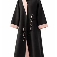 Black abaya with blush pink shawl lapels and cuffs and a diagonal row of black beaded loop motifs, cut to measure by The Lamorah Dubai