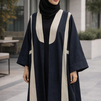 Woman wearing a black and beige abaya outdoors. |THE LAMORAH
