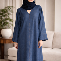 Woman wearing a blue abaya in a living room setting | THE LAMORAH