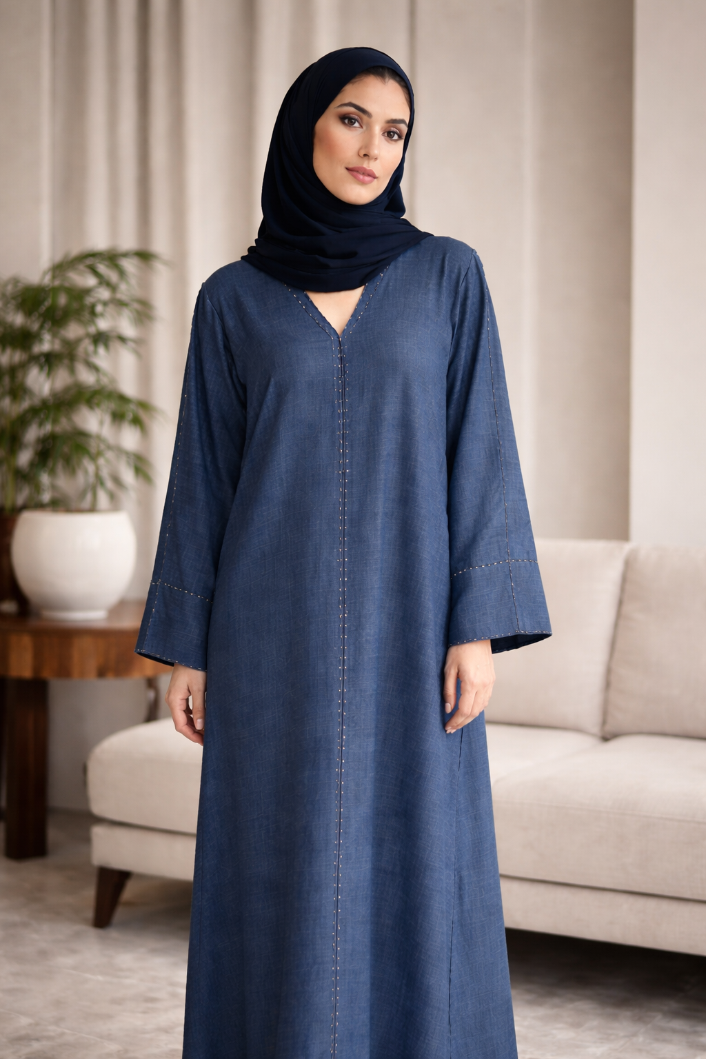 Woman wearing a blue abaya in a living room setting | THE LAMORAH