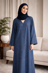 Woman wearing a blue abaya in a living room setting | THE LAMORAH