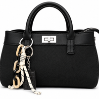 Black woven canvas mini tote with black leather trim, silver twist lock and a chocolate bar charm, from The Lamorah Dubai