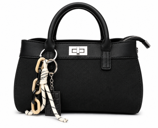 Black woven canvas mini tote with black leather trim, silver twist lock and a chocolate bar charm, from The Lamorah Dubai