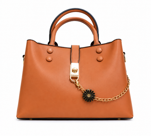 Caramel smooth leather shoulder tote with a gold chain and black daisy charm across the front, from The Lamorah Dubai