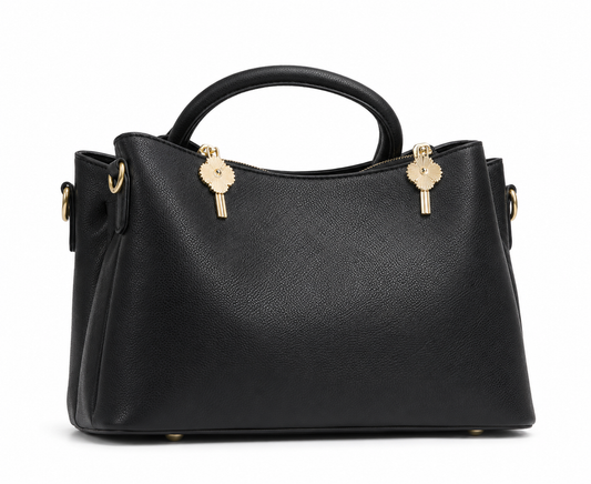 Black pebbled leather satchel with winged sides, two rolled top handles and twin gold sunburst zip pulls, from The Lamorah Dubai