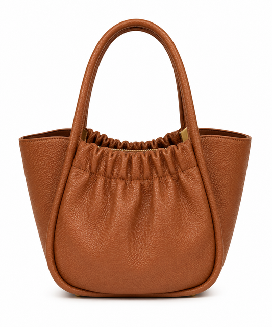 Cognac pebbled leather bucket tote with a gathered front panel and winged top, from The Lamorah Dubai