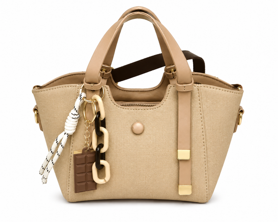 Sand woven canvas winged tote with tan leather handles, a long brown crossbody strap and a chocolate bar charm, from The Lamorah Dubai
