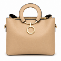 Sand pebbled leather tote with a round padded ring handle and a hanging gold octagon ring, from The Lamorah Dubai