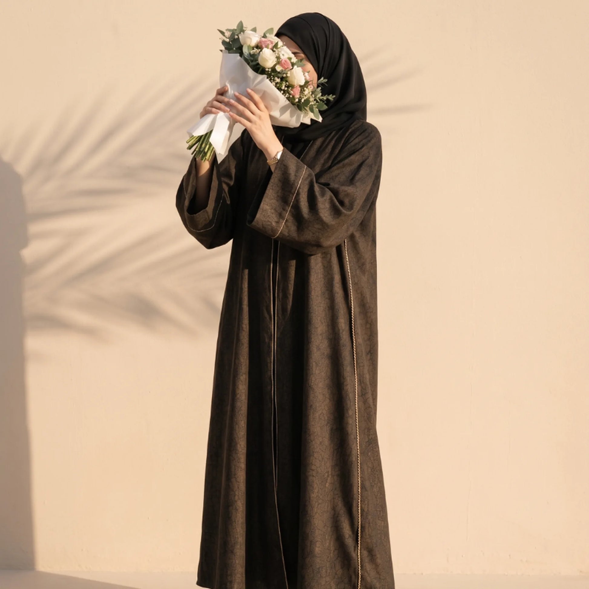 Bronze abaya with fine gold cord trim down both front edges, worn standing