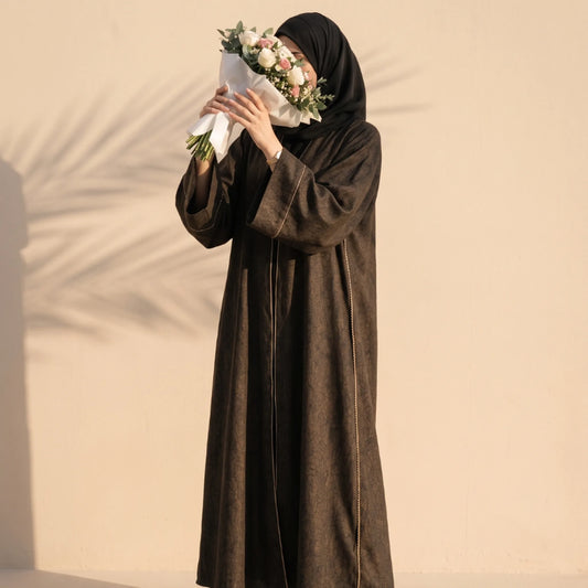 Bronze abaya with fine gold cord trim down both front edges, worn standing