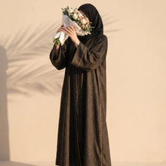 Bronze abaya with fine gold cord trim down both front edges, worn standing