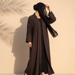 Chocolate brown open-front abaya with a scatter of diamante on the cuffs, worn standing