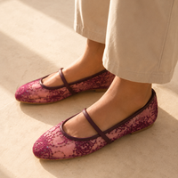 The burgundy lace Mary Jane flats worn with wide stone trousers in the sun, from The Lamorah Dubai