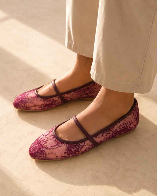 The burgundy lace Mary Jane flats worn with wide stone trousers in the sun, from The Lamorah Dubai