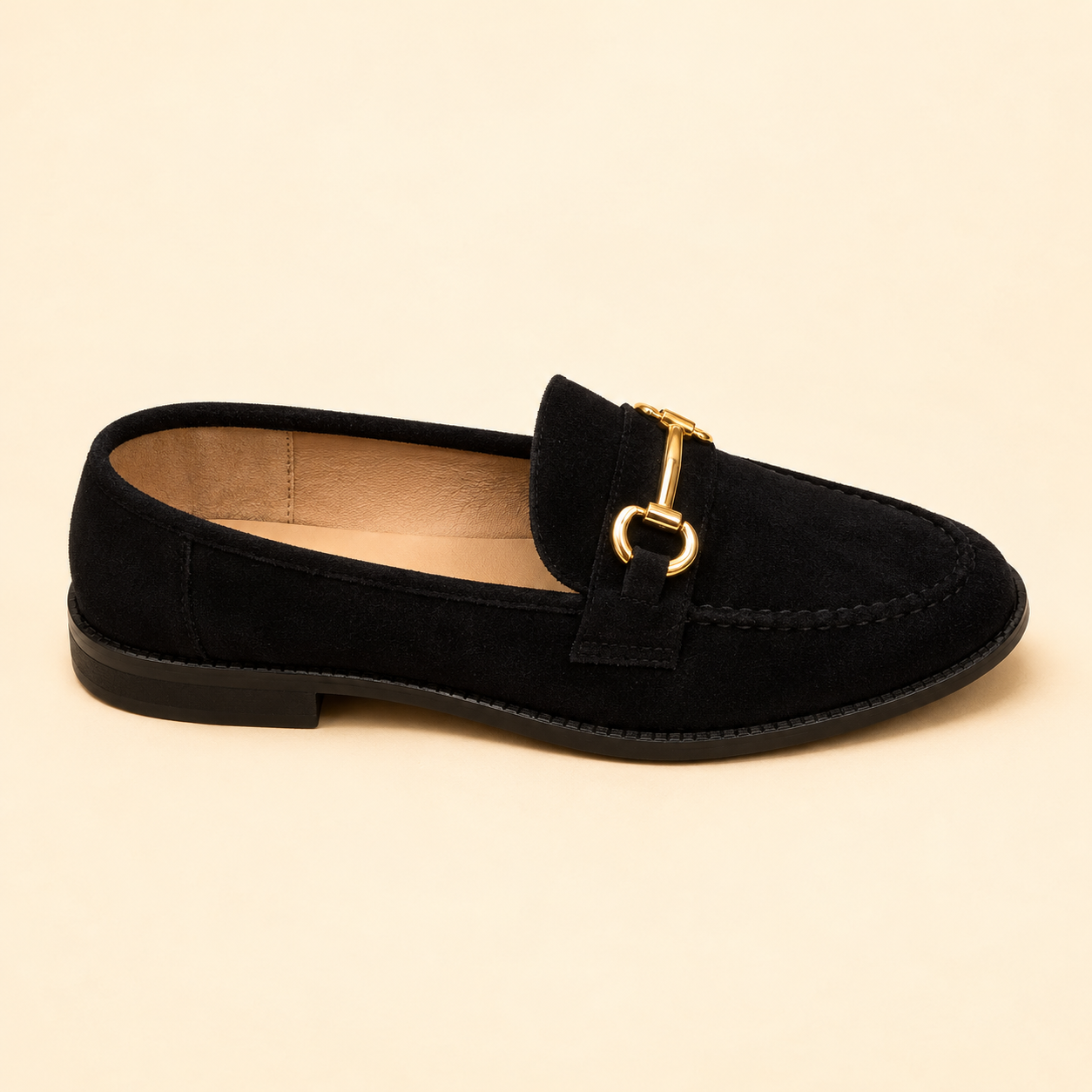 Black suede loafer with a stitched moccasin toe and a slim gold bar across the strap, from The Lamorah Dubai