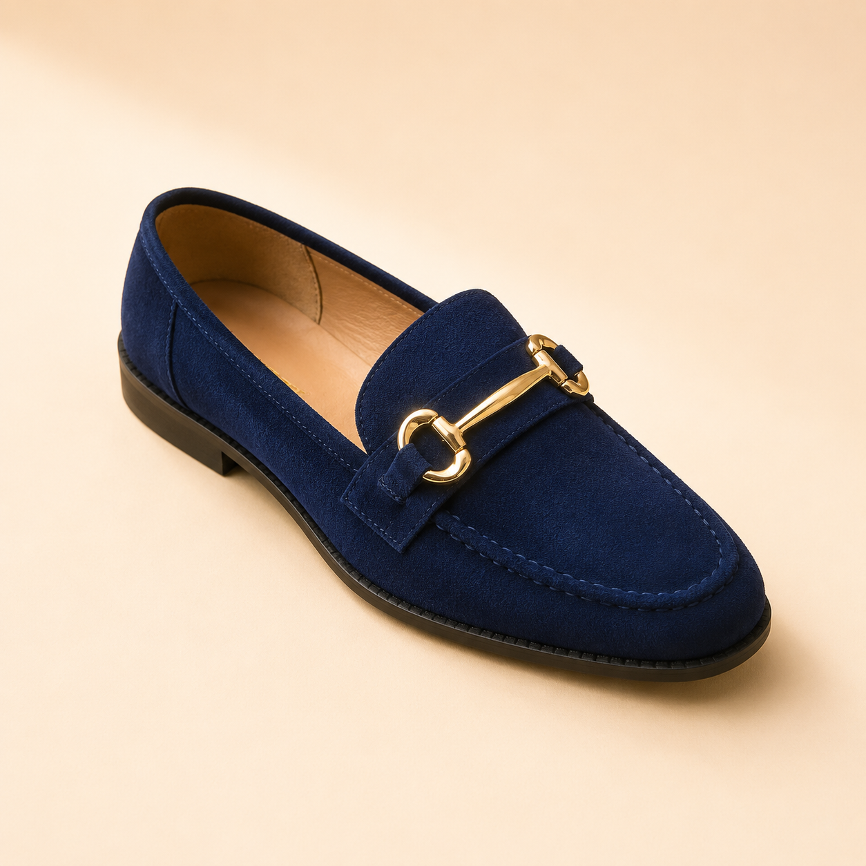 Navy suede loafer with a stitched moccasin toe and a slim gold bar across the strap, from The Lamorah Dubai